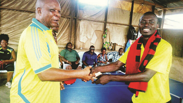  Derek Abrefa (right) receiving an award from an official of the tournament