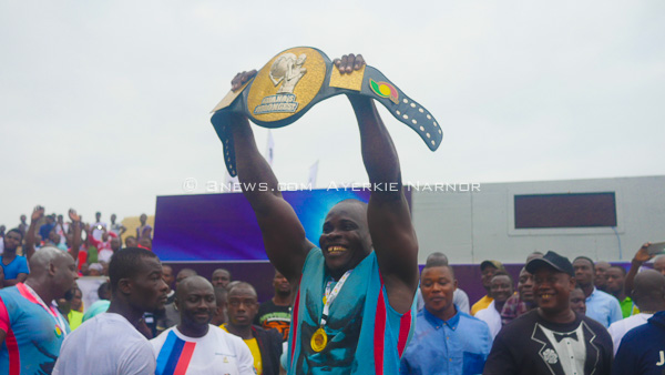 Courage Adukpo proudly displays the Ghana's strongest title belt