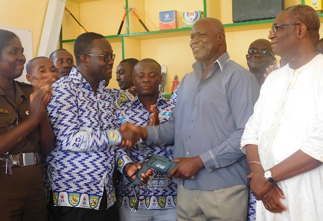 Dr Philip K.Amoo (left) presenting a hand drilling machine to ASP Joseph Kaduah (right) as Hon.Agyarko looks on