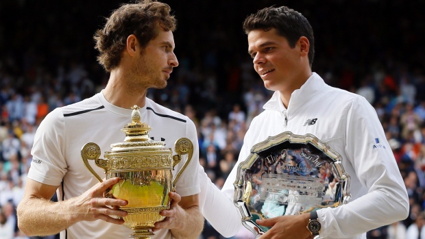 Andy Murray of Britain holds up his trophy after beating Milos Raonic of Canada (right)