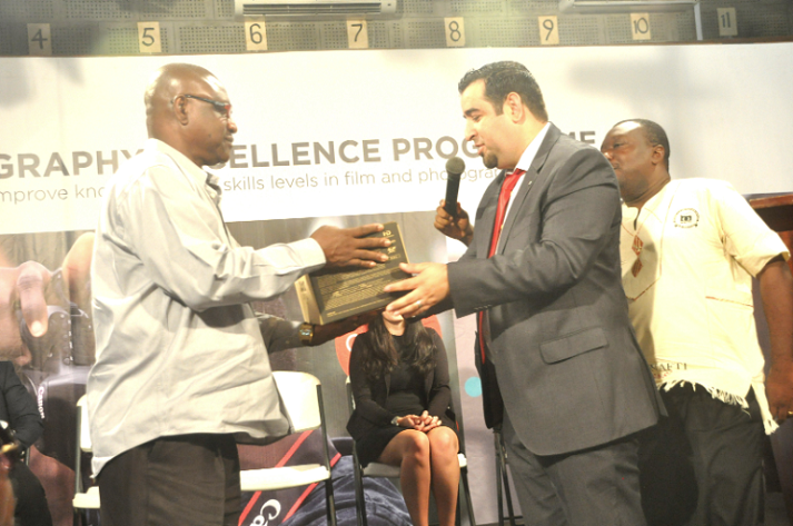  Mr Amine Djouahra (right), the Manager for Canon Central and North Africa, presenting one of the Canon products to Prof. Linus Abraham (left), Rector, NAFTI, in Accra. Picture: SAMUEL TEI ADANO