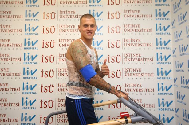 Martin Skrtel gives a thumbs up as he prepares to sign for Fenerbahce