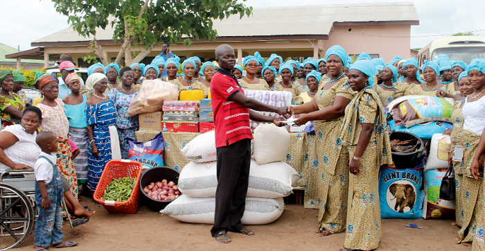 Mrs Ella Attih presenting the items to Mr Nelson Atiko (left), with Mrs Enyonam Ganyo-Tefe (right) looking on