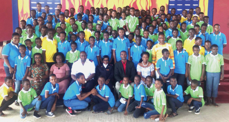 Members of the Tema Salvation Army School Girls Club in a group photograph with invited guests during the inauguration