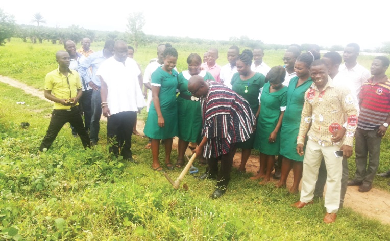 Mr Martin Kudor Kidibi cutting the sod for the nurses' quarters and water project.