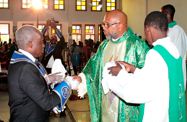 Rev. Father Andrew Anumu Quaye-Foli (right), Parish Priest, St Charles Lwanga Catholic Church, in a handshake with Worthy Brother Evaristus Kwatsinu (left), Regional Grand Knight of the Accra West Regional Council Picture: MAXWELL OCLOO