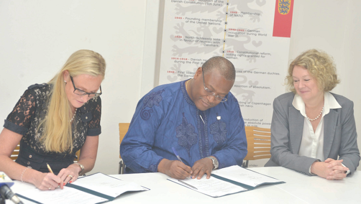 Mr Alex Segbefia, the Minister of Health, and Ms Emma Jacobsson (left) signing the agreement on behalf of their respective organisations. With them is Ms Tove Degnbol, Danish Ambassador to Ghana.
