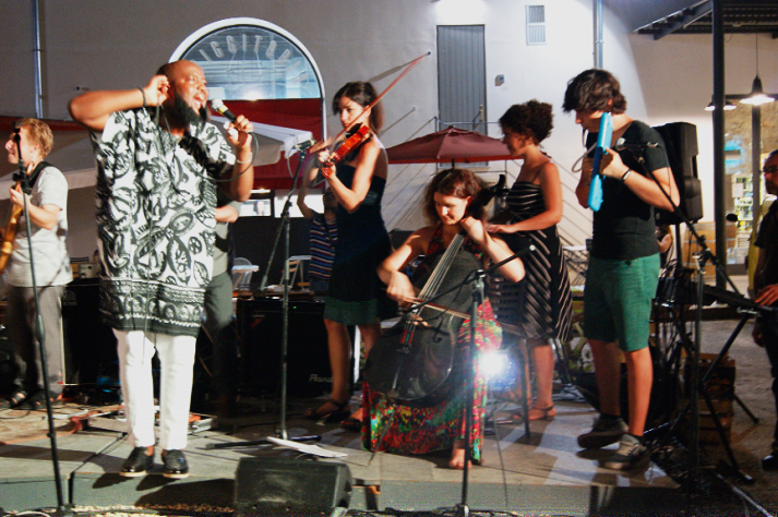 Trigmatic (holding mic) and colleagues on stage in Palermo, Italy.