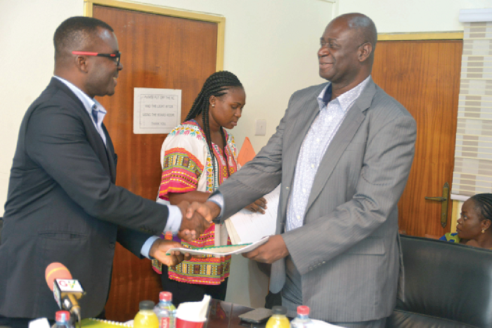 Mr Camynta Baezie,Executive Chairman of the State Enterprises Commission (SEC), exchanging documents with Dr Samuel Sarpong, Managing Director of the State Housing Company(SHC), after signing the agreement. Picture: EMMANUEL QUAYE