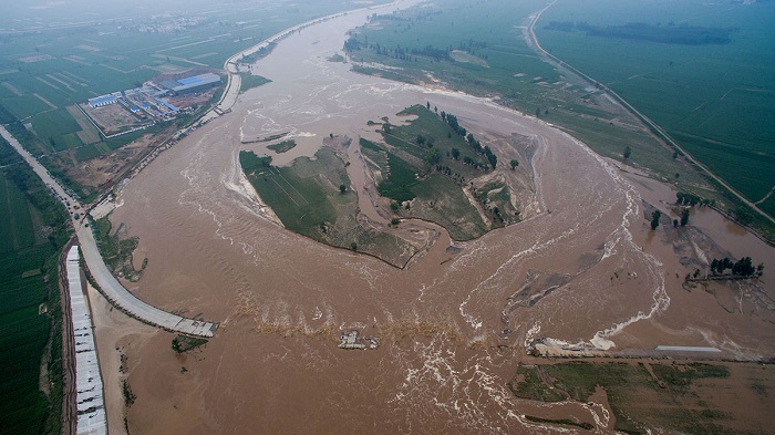 At least 154 people killed and thousands displaced as heavy rain triggers floods and landslides in parts of China.