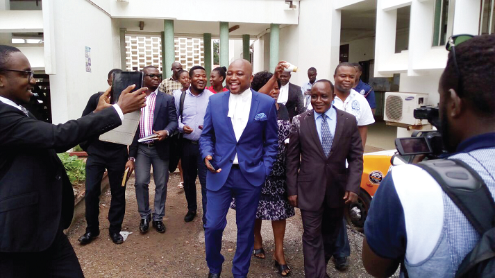 Mr Eric Amoateng (right) leaving the court premises with smiles after his acquittal