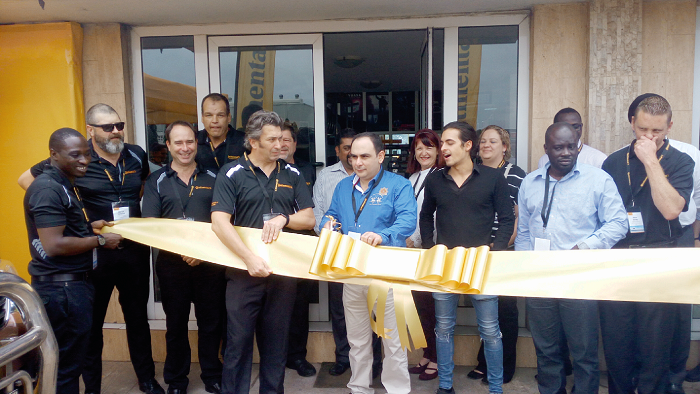 Mr Ahmed Fattal (middle), the Chief Executive Officer of Rainbow Motors, cutting the tape to open the showroom, with him is Mr Shaun Uys (4th left) and other officials of Continental tyre