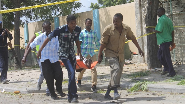 At least 10 killed as suicide bomber rams car into Criminal Investigation Department building in Somali capital.
