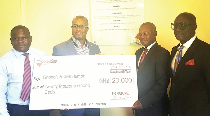 Mr Snowden (left) presenting a dummy cheque to Nana Osei Kyerematen. Looking on is Reks Brobbey (right)