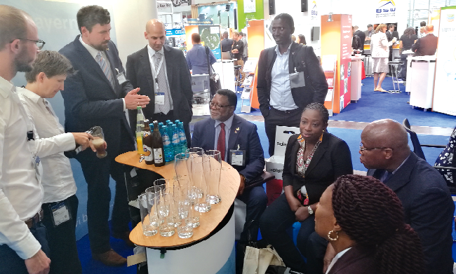 Mr Sebastian Stawowski interacting with the delegation at their stand at InterSolar 2016. With him include Mr Michael Neulinger (4th left) and Dr Ampofo (seated left)