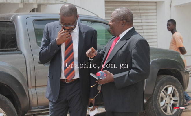 Mr Martin Amidu (left) in court on Thursday in a chat with colleague lawyer Ace Ankomah