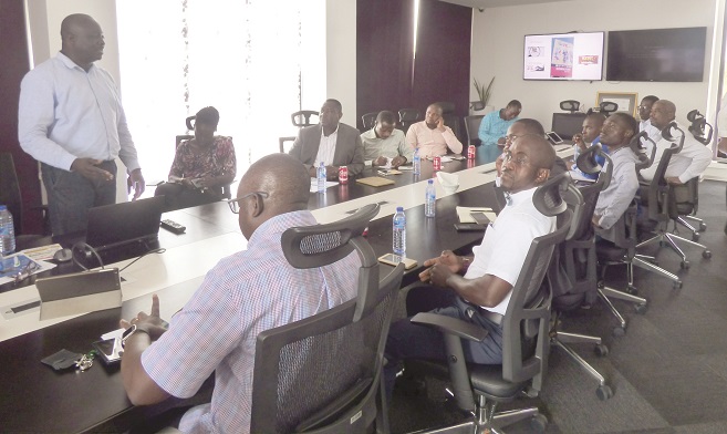 Nii Amah Dagadu (standing) supports Country Manager, Cecil Sunkwa-Mills (arrowed) to address members of the Network of Comm. Reporters.