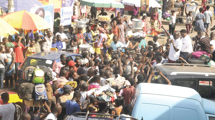   Dr Papa Kwesi Nduom (right) addressing  traders at the Takoradi market square. Picture: GABRIEL AHIABOR