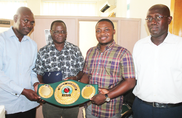 Prince Randy Opoku-Afriyie (2nd right) presenting the belt to the Editor, Graphic Sports, Felix Abayateye (2nd left) with them are Nat Laryea (left) and Ekow Asmah, both members of Baby Jet Promotions