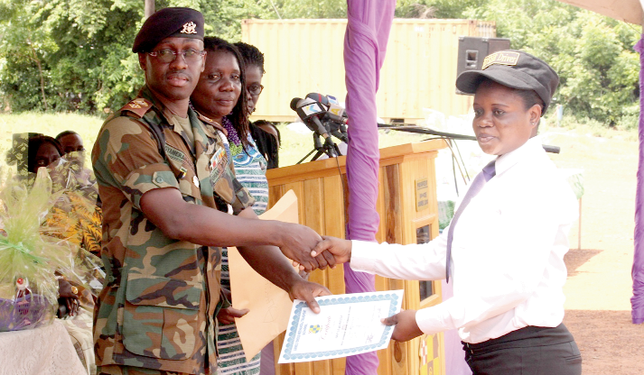 Lt. Col Franklin Gyamera-Amoako (left), Chief Instructor, Young Women in Professional Driving, presenting a certificate to Ms Alhassan Nafisa, a beneficiary of the programme. Picture: NII MARTEY M. BOTCHWAY