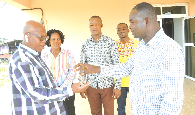 Mr Wakpali presenting the keys to the building to Mr Jerry Akwei Thompson. Looking on are some officials of the Municipal Assembly. Picture by EBOW HANSON