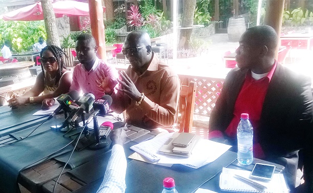 Dr Nana Agyenim Boateng flanked by some party executives while addressing the press