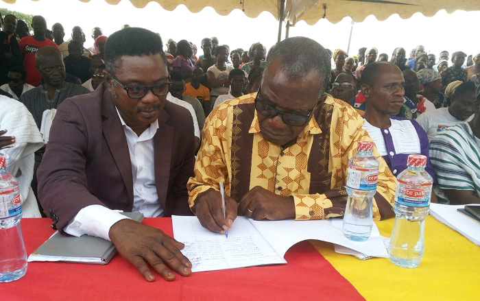 The Deputy Chief of Staff, Mr Kenneth Wujanji, signing the book of peace