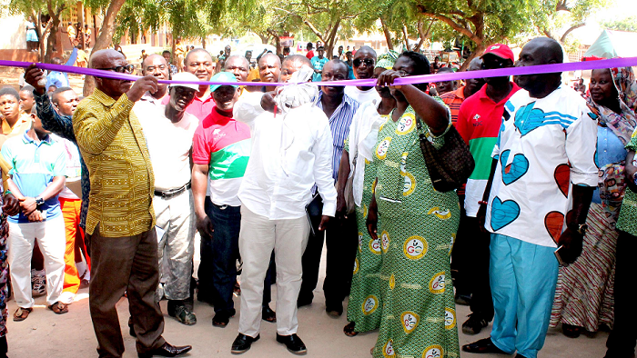  Mr Bright E. K Demordzi (middle) being   assisted to inaugurate the  school building present are officials from GES