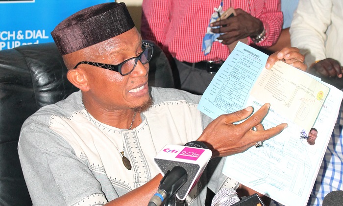 Sheikh Mustapha Hamid, aide to Nana Akufo-Addo, showing the documents on the Mitsubishi Pajero with registration number GS 687-16, allegedly presented to Mr Bugri Naabu