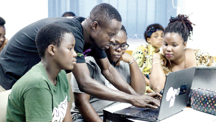 Mr Berchie taking some wikipedian women's page editors through an editing process during the project launch