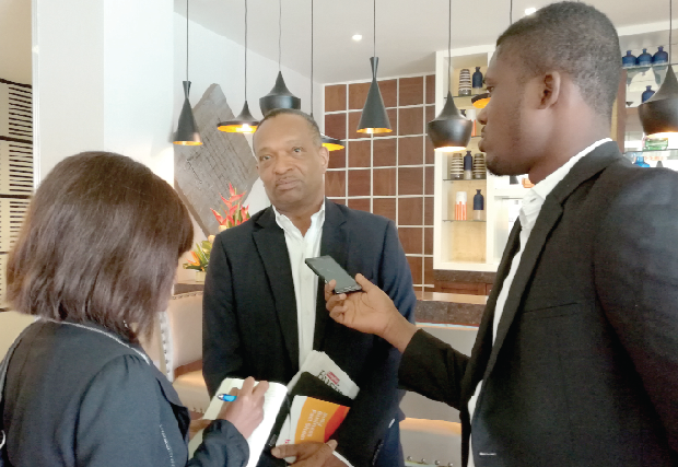 Mr Kweku Awotwi ( middle) interacting with  the media