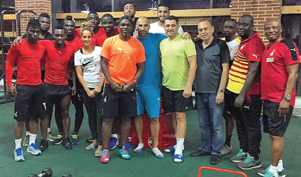 Black Stars coach Avram Grant (3rd from right) poses with his technical staff and some of his players at the team’s  training camp in Dubai