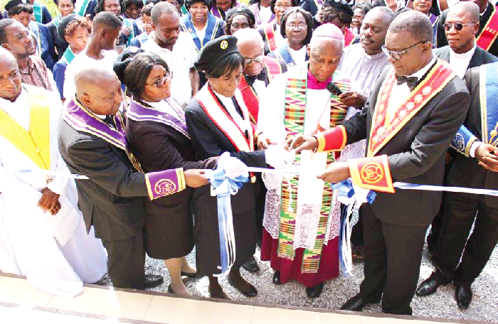 Most Rev. John Afoakwah (in cassock) being assisted by Bro Osei-Wusuansah (right) and Noble Lady, Sis Osei-Wusuansah, to cut the tape to inaugurate the twin-temple. Inset: The temple