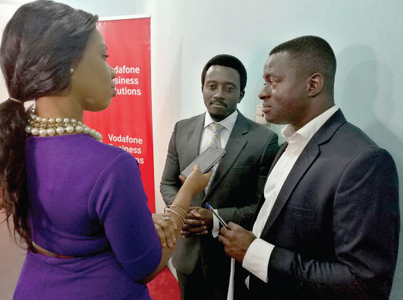 Mr Yaw Asamoah and Mr Caleb Ayiku (middle) interacting with Vivian Kai Lokko, a journalist
