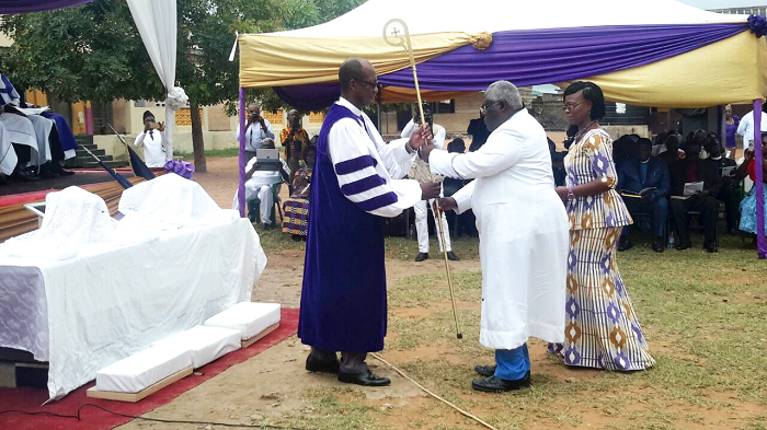 The Bishop Administrative Officer for the East Ghana Conference of the AMA Zion Church, Rev. Anthony Mensah (middle), presenting the staff to Rt Rev. Dr Dogbe