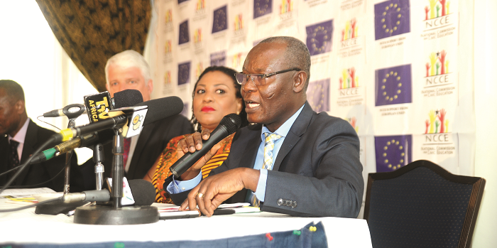  Mr Samuel Asare Akuamoah (right), the NCCE  Deputy Chairman, Operations, addressing participants