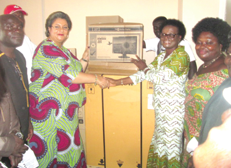 Ms Hanna Serwaa Tetteh (left) presenting a desktop computer to Mrs Anna Belinda Baidoo, the Awutu Senya District Director of Education