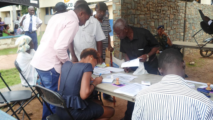 Some DKM customers in Sunyani going through documentation for payment. Picture: EMMANUEL ADU-GYAMERAH