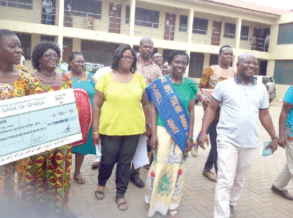 Mrs Rita Oppong (second right) being conducted round the assembly offices by the MCE, Mr Angenu (right). On her right is the Municipal Director of Education, Mrs Angela Tena Mensah
