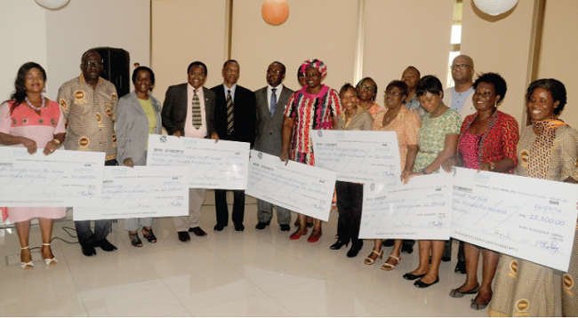 Dr Abiba Zakariah (5th right) with some institutional heads after receiving their cheques at a ceremony in Accra