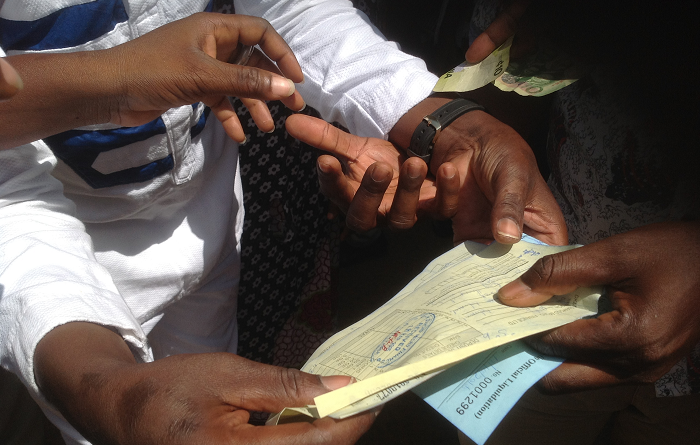  Some of the customers showing documents and the gh¢10 to prove their point