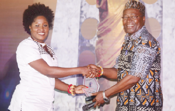 Patience (left) taking her award for being an inspiration
