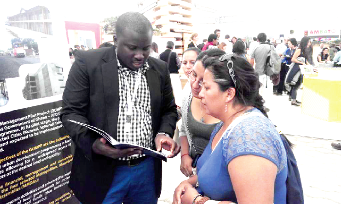 Mr Mohammed Mahama Adams, Communications Officer at Zoomlion Ghana, explaining a point to some of the  delegate
