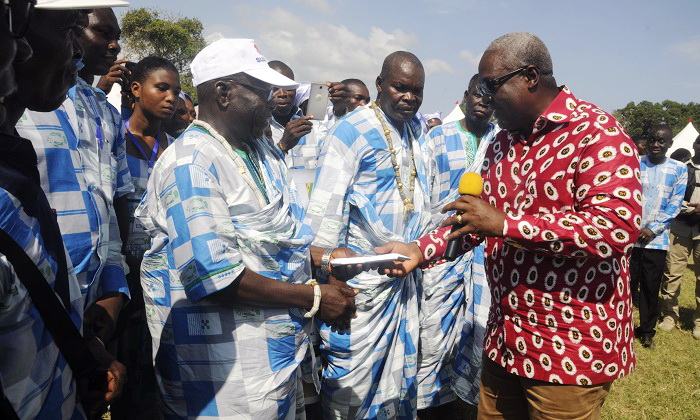 President John Mahama presenting a parcel to the Chairman of the Adina landing beach committee at the fish festival