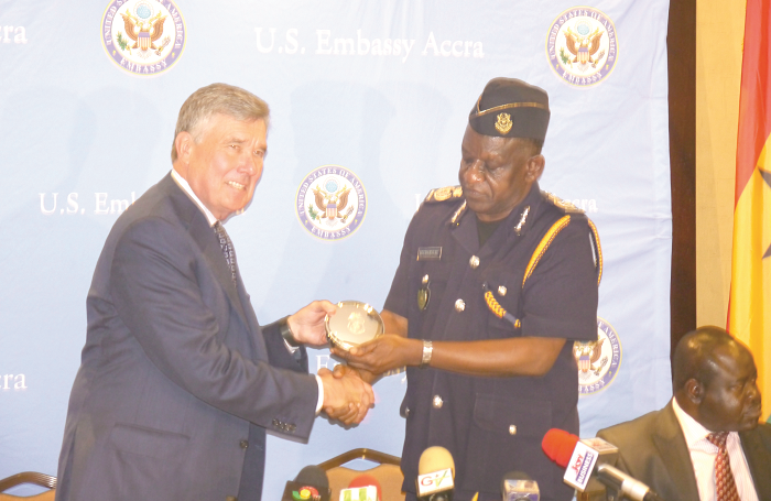  Mr R. Gil Kerlikowske (left), the Commissioner of the United States Customs and Border Protection, presenting a gift to Mr John Vianney Kuudamnuru (right), Commissioner-Customs Division, Ghana Revenue Authority, at the round-table conference held in Accra. Picture: PATRICK DICKSON 