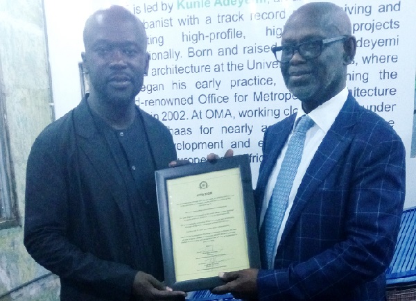 Mr David Adjaye (leftt) receiving the citation from Professor Kwesi Botchwey, Chairman of the NDPC
