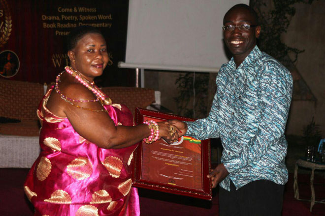 The Queenmother of Apam, Nana Essel Botwe presenting a citation to Dr Michael Osei Agyapong, winner of the Ananse Prize for Literature by the Ghana Writers Awards