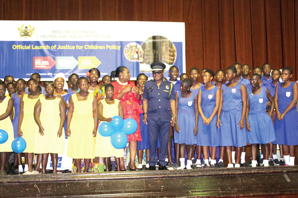 The IGP, Mr John Kudalor and Nana Oye Lithur in a group photograph with some of the school children at the launch