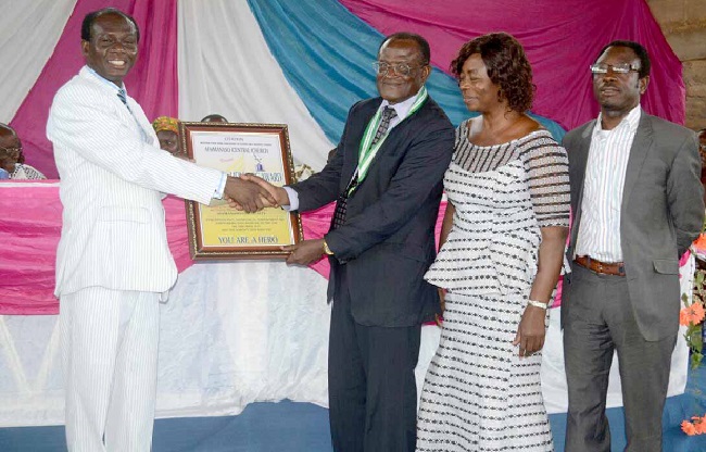 Dr Oti Agyen (left) presenting a citation to Pastor Dr I. B. Boateng of the Valley View University (VVU) for his contribution to the development of Afamanso
