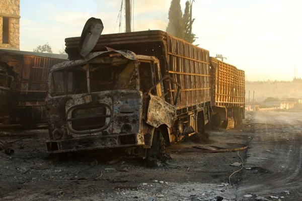 Damaged aid trucks stand near the rebel-held town of Urum al-Kubra